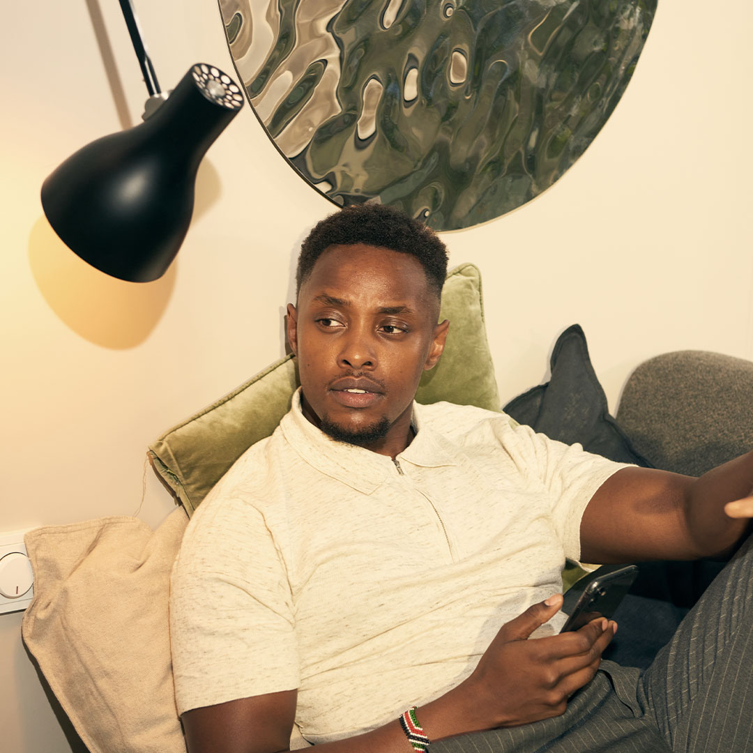 Young man sitting in couch