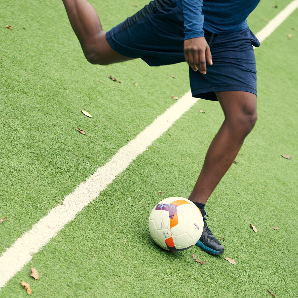 Person kicking to a football