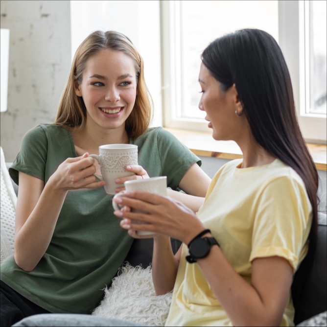 Two girls drinking coffee